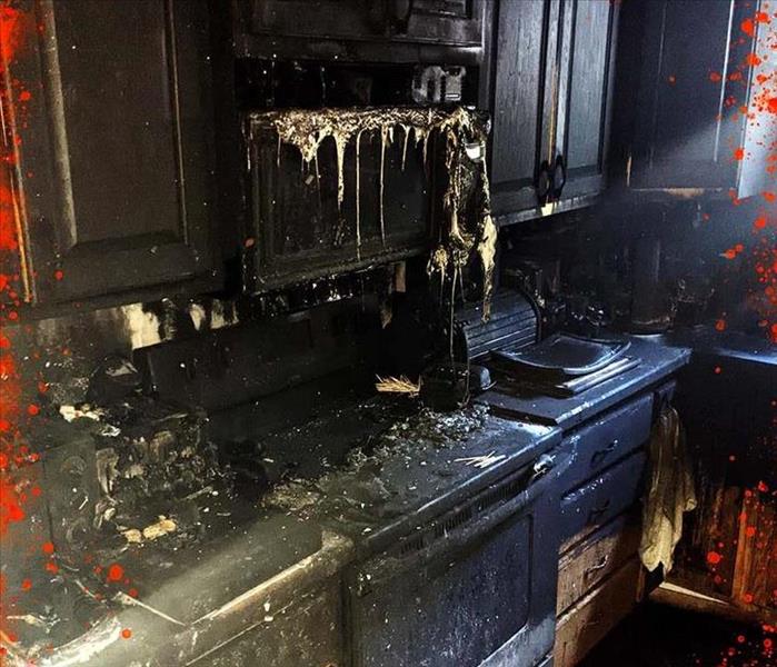 fire damage image from kitchen in minot where microwave is melting onto stovetop